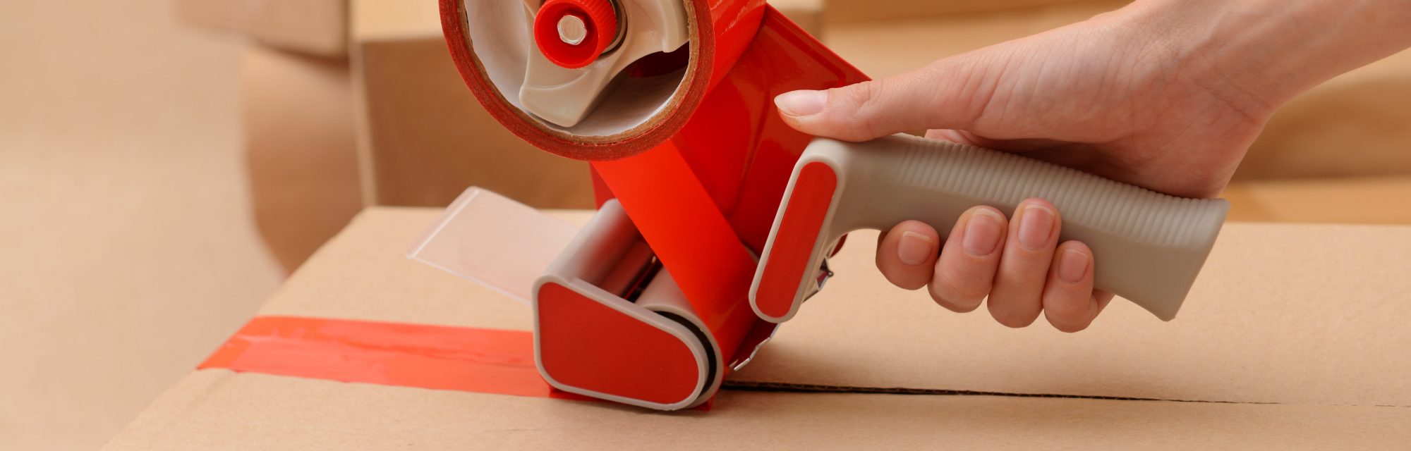 Tape dispenser packaging box with red tape